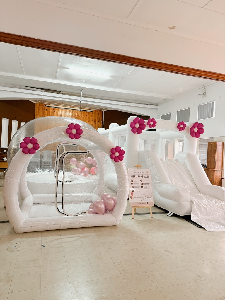 Indoor setup with bubble dome and white inflatable slide