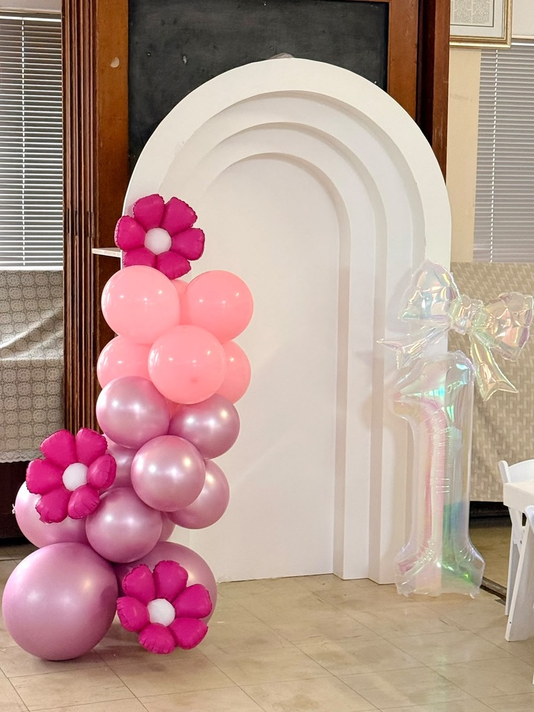 Wooden arch backdrop with pink balloon garland