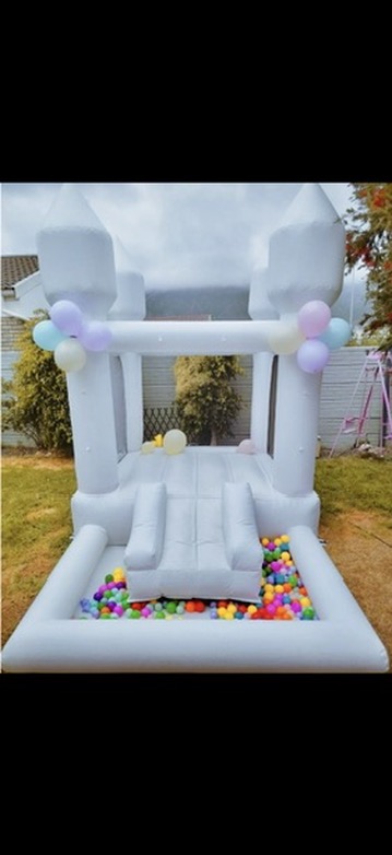 Mini white castle with slide and colourful ballpit
